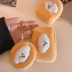 Close-up of fluffy plush puppy coin purse with white dog detail and red bow knot