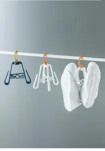 Detail of rotating shoe drying rack showing foldable arms for double storage capacity