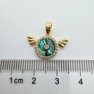 Detailed view of 18K gold-plated abalone shell wing pendant with size scale reference
