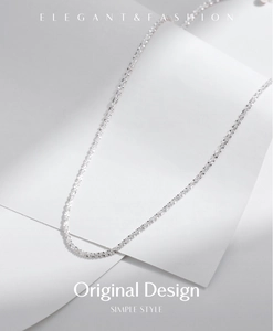 Minimalist silver chain necklace detail showing delicate links and metallic luster