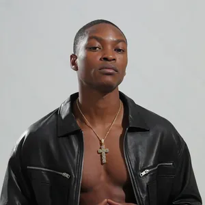 Close-up of hip hop gold cross pendant with micro-pave zircons worn by a male model