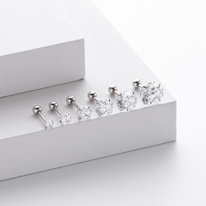 Macro view of six silver screw back earrings with clear cubic zirconia in gradient sizes