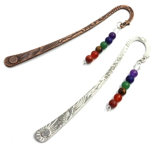 Detailed view of bronze and silver feather bookmarks with chakra crystal beads