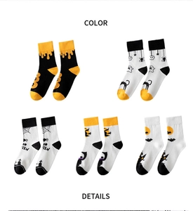 Detail view of five pairs of cotton Halloween crew socks with various spooky patterns