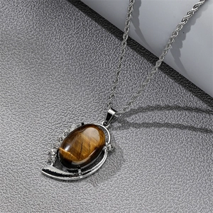 Detail of silver twisted chain necklace with oval tiger eye stone and crystal inlay