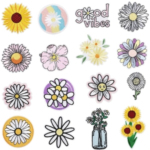 Macro detail of colorful floral embroidery patches with sun flowers and good vibes text