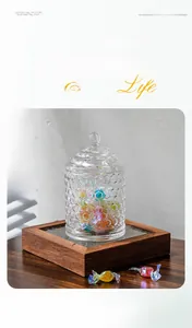 Detailed close-up of European honeycomb glass jar with candies on a dark wood tray