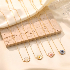 Minimalist gold eight-pointed star pendant necklace set with four assorted colored crystals