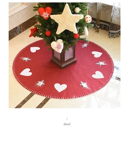 Detail of red wool felt Christmas tree skirt with heart sequins and bearded gnome decor