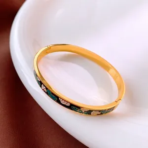 Bracelet vintage en acier inoxydable doré avec des motifs floraux en émail coloré