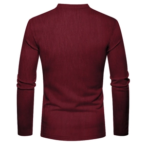 Macro shot of burgundy ribbed knit fabric on a slim-fit long-sleeve men's henley shirt