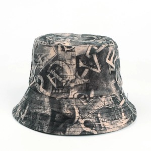 Detail of khaki bucket hat with black graffiti letters and reinforced stitching on brim