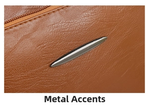 Detail shot of brown lychee grain leather with silver shuttle-shaped metal decoration