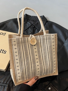 Linen tote bag with vertical stripes, rope handles, and a large wooden button closure