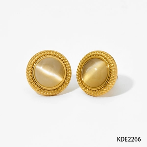 Close-up of vintage gold stud earrings with round champagne cat-eye stones and beaded edges