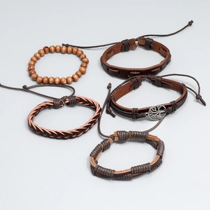 Detail of 5-piece multilayer leather bracelet set with tree of life charm and wood beads