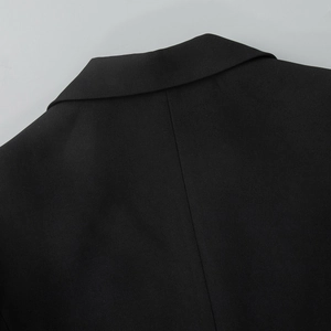Close-up of high-quality black suit collar with fine stitching and lace detail