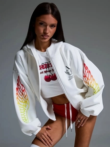 Detail of hoodie sleeve showing orange gradient wing graphic and white cotton texture