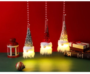 Detail view of glowing Christmas gnomes with LED lights in red and grey sequin hats
