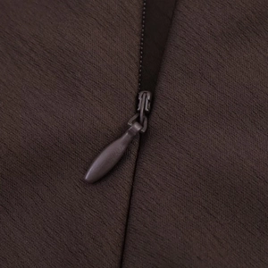 Macro detail of high-quality brown satin fabric with a matching invisible teardrop zipper