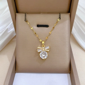 Macro view of gold butterfly pendant with sparkling zircon set in a premium jewelry box