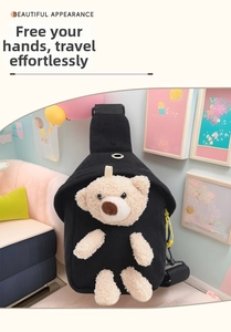 Detail of a black canvas kids chest bag featuring a cute 3D plush teddy bear and yellow zipper