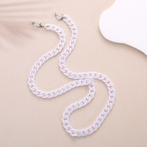 Detail of white pearl eyeglass chain with metal clasps and silicone loops on soft background