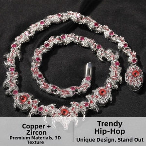 Macro shot of silver-tone hip-hop necklace with red cubic zirconia spikes