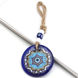 Detailed close-up of blue glass evil eye pendant with mandala pattern and hemp rope