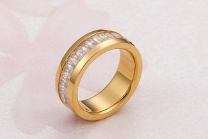 Detail view of gold stainless steel ring with baguette-cut clear zircon stones