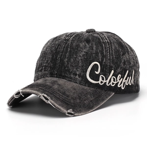 Detail of embroidered 'Colorful' text and distressed brim on grey washed denim baseball cap