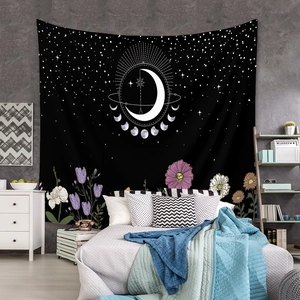 Detail of bohemian moon phase tapestry with floral accents on a bedroom wall