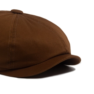 Minimalist dark brown cotton newsboy cap featuring detailed stitching and premium crown button