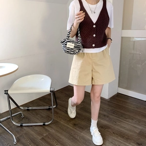 Fashionable zebra print mini tote bag with retro knit vest and casual shorts outfit