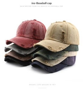 Detail view of distressed cotton baseball caps in eight vintage colors with torn edges