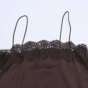 Detailed close-up of brown satin camisole with delicate black eyelash lace neckline