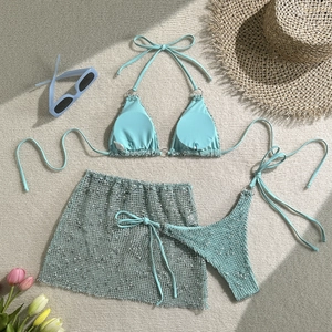 Three-piece bikini set with textured mesh fabric and matching cover-up wrap skirt