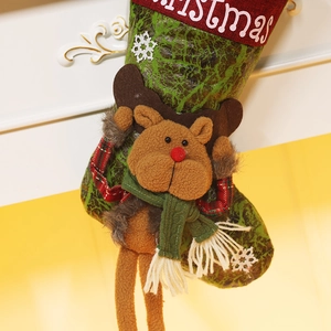 Close-up of green Christmas stocking with 3D plush reindeer and red knitted cuff details