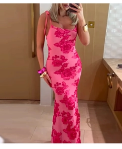 Detailed close-up of pink lace maxi dress with red floral embroidery and slim straps