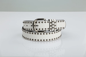 Detail of white leather belt with double rows of metal rivets and polished buckle