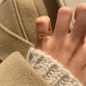 Minimalist 925 sterling silver open heart ring for women in gold finish on finger
