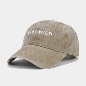 Detailed close-up of embroidered STAY WILD text on washed vintage baseball cap
