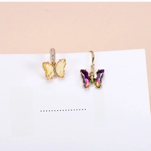 Detail of crystal butterfly earrings with gradient multi-faceted cut and gold diamond hooks