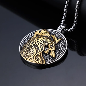 Macro side view of Norse Viking wolf totem pendant with gold and silver dual-tone finish