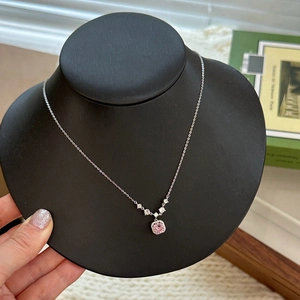 Detailed macro view of S925 silver necklace with pink square zirconia on a black mannequin