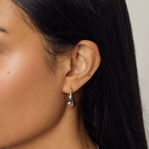 Modern gold and silver two-tone teardrop earrings in a minimalist geometric style