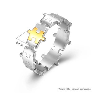 Detail showing 8mm puzzle piece ring in stainless steel with a single gold highlight
