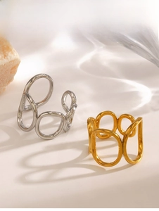Detail of gold and silver hollow geometric oval rings with elegant water ripple shadows