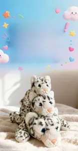 Three-piece set of plush snow leopards in large, medium, and small sizes with blue eyes