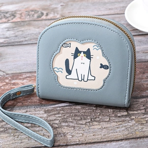 Short blue PU leather wallet with cartoon cat embroidery and wrist strap on wooden table